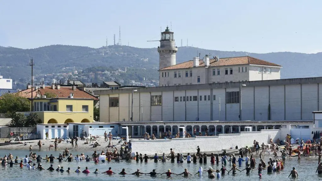 Italy: Trieste residents, women and men, bathe dressed in support of Muslim women in burkini